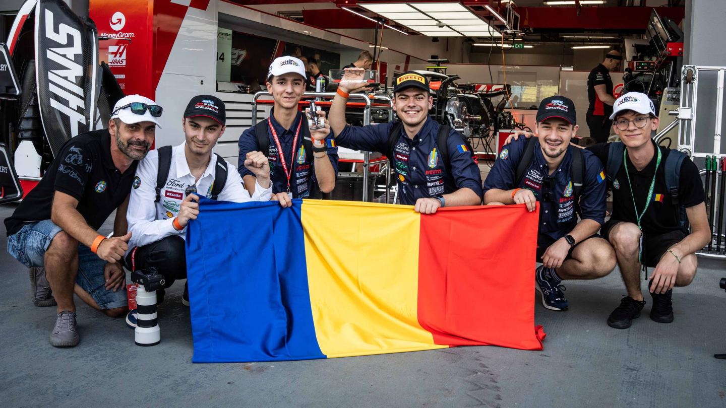 F1 in schools Team Romania pose in front of the MoneyGram Haas F1 Team garage in Singapore