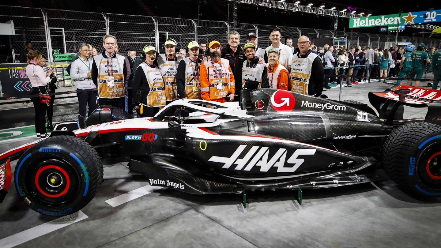 F1 in schools Team Romania pose in front of the MoneyGram Haas F1 Team garage in Singapore